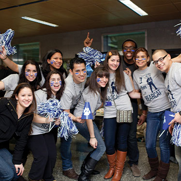 Group of people with streamers and face paint smiling. Read about Gifts That Pay You Income Group of people with streamers and face paint smiling. Read about Gifts That Pay You Income