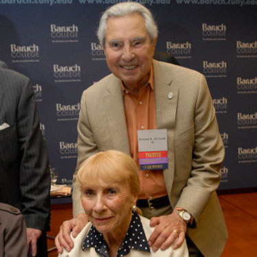 Couple taking photo together in front of Baruch wall. Read about Gifts of Life Insurance Couple taking photo together in front of Baruch wall. Read about Gifts of Life Insurance