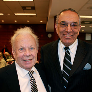 Two men in suit and tie smiling at camera. Read about Gifts of Appreciated Securities Two men in suit and tie smiling at camera. Read about Gifts of Appreciated Securities