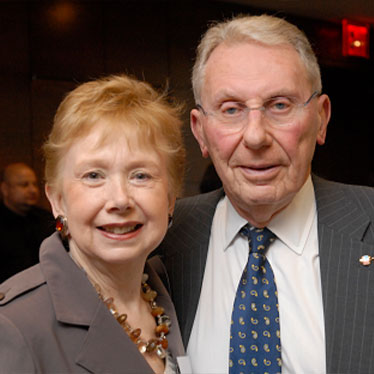 Couple standing together smiling. Read about Gifts of Real Estate Couple standing together smiling. Read about Gifts of Real Estate